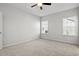 This bedroom features neutral carpet, a ceiling fan and two windows for natural light at 3336 Little Bay Dr., Conway, SC 29526