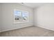 This bedroom features neutral carpet and a large window that provides plenty of natural light at 3336 Little Bay Dr., Conway, SC 29526