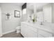 Bright bathroom with double sink vanity, white cabinets, and framed mirrors, offering a clean, modern aesthetic at 342 Myrtle Meadows Dr # 463F, Conway, SC 29526