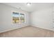 Bright bedroom featuring neutral walls, tan carpet, and a large window with a view at 343 Barn Owl Way, Conway, SC 29527