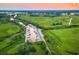 Aerial view of a marina with boats docked, surrounded by lush greenery and waterways at 35 Red Skiff Ln. # 35, Pawleys Island, SC 29585