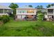 Beautiful backyard view from above, featuring a lush lawn, spacious deck, and inviting outdoor seating at 35 Red Skiff Ln. # 35, Pawleys Island, SC 29585