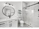 Modern bathroom features a glass shower, white vanity, round mirror, and a shelving unit with towels at 35 Red Skiff Ln. # 35, Pawleys Island, SC 29585