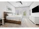 Bright bedroom features a king bed, cool color palette, and hardwood floors at 35 Red Skiff Ln. # 35, Pawleys Island, SC 29585