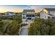 Charming beach house exterior with large windows, dune vegetation, and a sandy pathway at 35 Red Skiff Ln. # 35, Pawleys Island, SC 29585