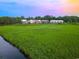 Scenic view of charming homes with a backdrop of lush greenery and a peaceful waterway at 35 Red Skiff Ln. # 35, Pawleys Island, SC 29585