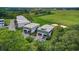 Aerial view of modern townhomes with attached garages, surrounded by lush landscaping and serene ponds at 35 Red Skiff Ln. # 35, Pawleys Island, SC 29585