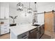 Bright kitchen features a bar with wine cooler, gray cabinets, and stainless steel sink at 35 Red Skiff Ln. # 35, Pawleys Island, SC 29585