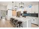 Modern kitchen features a large island with seating, pendant lighting, and white cabinets at 35 Red Skiff Ln. # 35, Pawleys Island, SC 29585