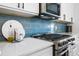 Well-equipped kitchen with stainless steel gas range and a stylish blue tile backsplash at 35 Red Skiff Ln. # 35, Pawleys Island, SC 29585