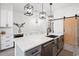 Kitchen island with white countertops, bar stools, and stylish pendant lighting above at 35 Red Skiff Ln. # 35, Pawleys Island, SC 29585