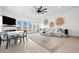 Bright living room with fireplace, large windows overlooking landscape and neutral decor at 35 Red Skiff Ln. # 35, Pawleys Island, SC 29585