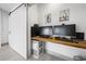 Home office with a wood desktop, two monitors, and a sliding barn door entrance at 35 Red Skiff Ln. # 35, Pawleys Island, SC 29585
