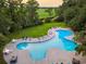Large, inviting pool area surrounded by lush greenery and comfortable lounge chairs at 35 Red Skiff Ln. # 35, Pawleys Island, SC 29585