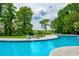 Sparkling pool surrounded by lush landscaping and comfortable lounge chairs at 35 Red Skiff Ln. # 35, Pawleys Island, SC 29585