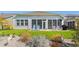 Charming patio with screened porch, lawn chairs, and well manicured garden at 363 Cypress Springs Way, Little River, SC 29566