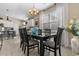 Dining room area with elegant chandelier, large windows, and seating for six at 363 Cypress Springs Way, Little River, SC 29566