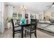 Dining room with modern table, six chairs, and an adjacent living area at 363 Cypress Springs Way, Little River, SC 29566