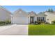 Charming single-story home featuring a two-car garage and well-manicured lawn at 363 Cypress Springs Way, Little River, SC 29566