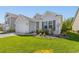 Landscaped front yard featuring decorative foliage, garden bed lighting, and well-kept lawn at 363 Cypress Springs Way, Little River, SC 29566