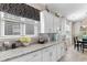Kitchen area featuring white cabinets, granite counters, and modern finishes at 363 Cypress Springs Way, Little River, SC 29566