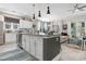 Open kitchen featuring white cabinets, granite counters, stainless appliances and adjacent living area at 363 Cypress Springs Way, Little River, SC 29566