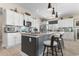 Bright kitchen featuring white cabinets, stainless steel appliances, a large island, and stylish pendant lighting at 363 Cypress Springs Way, Little River, SC 29566