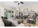 Cozy living room with a ceiling fan, comfortable seating, stylish decor, and sliding glass doors to a screened-in porch at 363 Cypress Springs Way, Little River, SC 29566