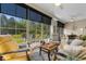 Cozy sunroom filled with natural light, comfortable seating, and views of the lush outdoor space at 363 Cypress Springs Way, Little River, SC 29566