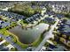 Aerial view of homes surrounding a pond with a fountain and lush green landscaping at 400 Woodpecker Ln. # 17B, Murrells Inlet, SC 29576