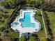 Aerial view of a uniquely shaped pool with seating surrounded by lush landscaping at 400 Woodpecker Ln. # 17B, Murrells Inlet, SC 29576