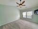 Bright bedroom featuring vaulted ceilings, ceiling fan, and a large window at 400 Woodpecker Ln. # 17B, Murrells Inlet, SC 29576