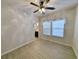 Bedroom with wood-look flooring, ceiling fan, and large window providing natural light at 400 Woodpecker Ln. # 17B, Murrells Inlet, SC 29576