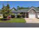 Charming brick home featuring a one-car garage, lush landscaping, and a well-maintained front yard at 400 Woodpecker Ln. # 17B, Murrells Inlet, SC 29576