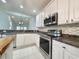 Updated kitchen features stainless steel appliances, granite countertops, and bright white cabinets at 400 Woodpecker Ln. # 17B, Murrells Inlet, SC 29576