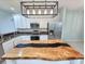 Modern kitchen with stainless appliances, granite counters, custom island, and stylish lighting at 400 Woodpecker Ln. # 17B, Murrells Inlet, SC 29576