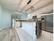 Bright open kitchen with white cabinets, stainless steel appliances, and an island with a unique wood countertop at 400 Woodpecker Ln. # 17B, Murrells Inlet, SC 29576