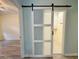 Laundry room entrance with sliding barn door at 400 Woodpecker Ln. # 17B, Murrells Inlet, SC 29576