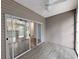 View of the patio with wood-look floor, ceiling fan, and a slider door at 400 Woodpecker Ln. # 17B, Murrells Inlet, SC 29576
