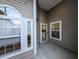 A view of an enclosed patio, showcasing large windows, white trim, and door leading to the backyard at 400 Woodpecker Ln. # 17B, Murrells Inlet, SC 29576