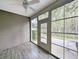 Relaxing screened porch featuring a ceiling fan and views of the surrounding landscape at 400 Woodpecker Ln. # 17B, Murrells Inlet, SC 29576
