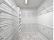 Spacious walk-in closet with adjustable white shelving and marble flooring at 400 Woodpecker Ln. # 17B, Murrells Inlet, SC 29576