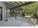 Spacious backyard featuring pergola, concrete patio, privacy fence, and mature trees at 405 Emerson Dr., Myrtle Beach, SC 29579