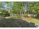 Spacious backyard with mature trees and wooden deck for outdoor living and entertaining at 405 Emerson Dr., Myrtle Beach, SC 29579