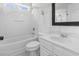This modern bathroom features wainscoting, white fixtures, and modern black framed mirror at 405 Emerson Dr., Myrtle Beach, SC 29579