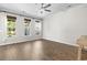 Bedroom with three large sunny windows, wood floors, ceiling fan and white trim at 405 Emerson Dr., Myrtle Beach, SC 29579