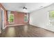 A spacious bedroom with hardwood floors and large windows offering ample natural light and a calm, airy ambiance at 405 Emerson Dr., Myrtle Beach, SC 29579