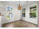 A naturally lit dining room featuring hardwood floors and large windows overlooking the yard at 405 Emerson Dr., Myrtle Beach, SC 29579