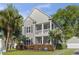Charming two-story home with a welcoming front porch, manicured lawn, and mature landscaping at 405 Emerson Dr., Myrtle Beach, SC 29579