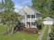 Charming two-story home with a red front door, a quaint porch and a lush, landscaped yard at 405 Emerson Dr., Myrtle Beach, SC 29579